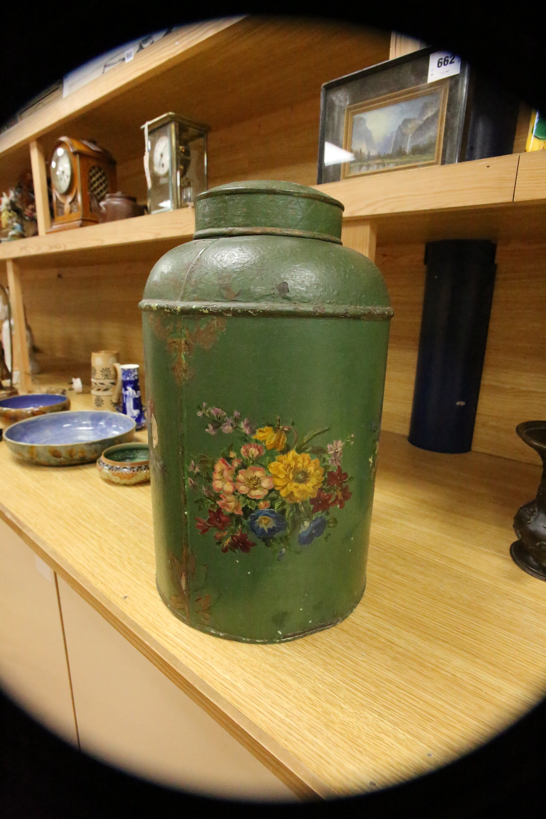 A green toleware floral decorated tea canister, 42cm high. Condition - poor, many chips to surface paint